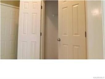 Laundry room is behind closed doors in mud room of