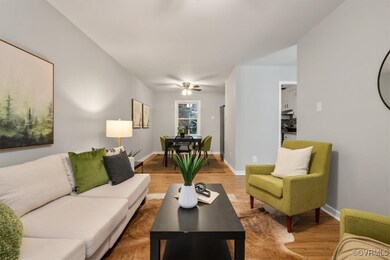 Living room with ceiling fan and wood-type floorin