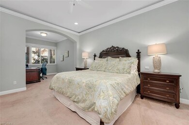 Bedroom featuring ornamental molding, light carpet
