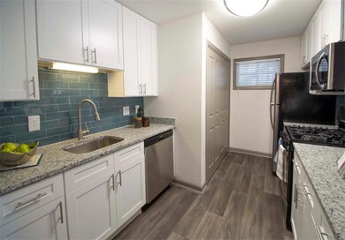 Kitchen with white cabinetry, stainless steel appl