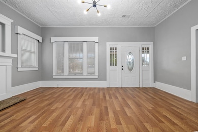 Entrance foyer with hardwood / wood-style floors and a textured ceiling