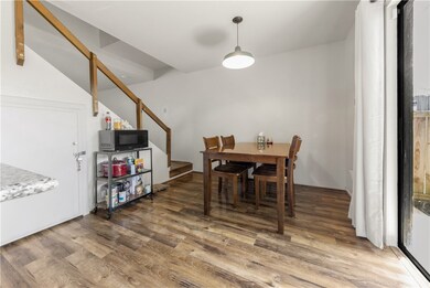 Dining space with stairway and wood finished floor