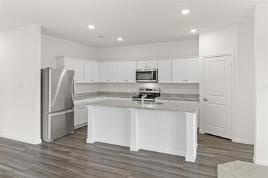 Kitchen with a center island with sink, appliances