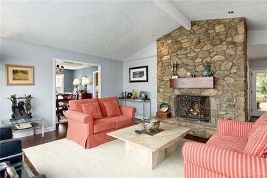 Lakefront living room connects to dining room and 