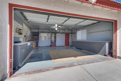 Garage featuring a garage door opener and secured