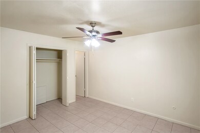 Unfurnished bedroom with a closet, baseboards, a c