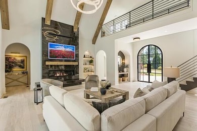 Living area with beamed ceiling, a fireplace, a to
