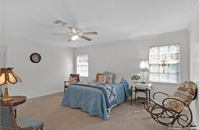 Carpeted bedroom with ornamental molding and ceili
