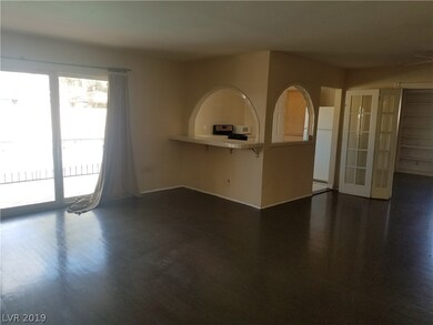 Living Room Looks Into Kitchen With Breakfast Bar.