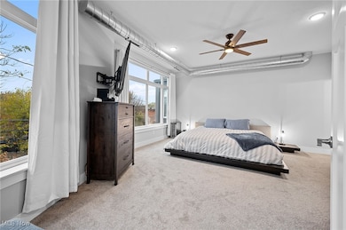 Carpeted bedroom featuring baseboards and a ceiling fan