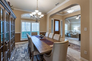 Tiled dining area featuring crown molding and ceil
