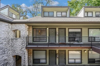 View of front of property featuring roof with shi