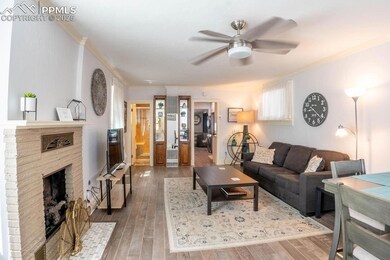 Living room with ornamental molding, ceiling fan, 