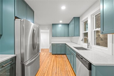 Kitchen with sink, stainless steel appliances, and light hardwood / wood-style flooring