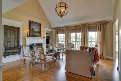 Living/great room with arched ceilings, fireplace, and broad views to the  backyard area
