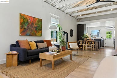 Living area with wooden ceiling, light wood-type flooring, and ceiling fan