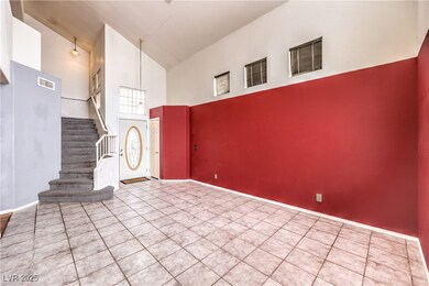 Tiled foyer featuring visible vents, stairway, hig
