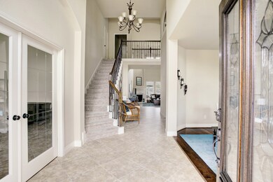As you walk in you're greeted with a two story entry way and sweeping staircase