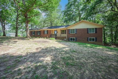 Single story home featuring covered porch and brick siding