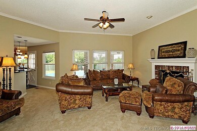 Spacious living area with high ceiling and large w