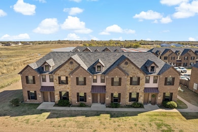 View of front of house featuring brick siding, a standing seam roof, a metal roof, and a front lawn