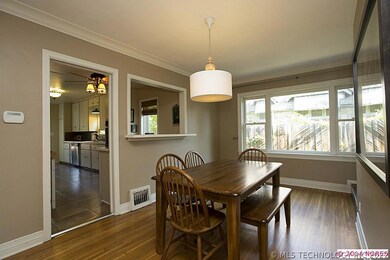 A sculpted archway opens to the dining room. Perfe