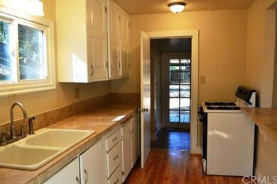 Tile kitchen with pass through to family room.