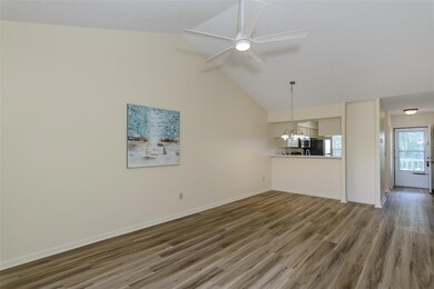 Great room, kitchen, and foyer. New ceiling fan and light fixture.