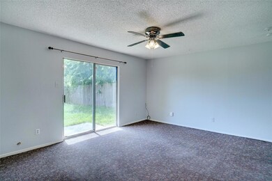 Unfurnished room with ceiling fan, dark colored ca