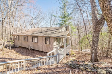 View of front of home featuring roof with shingles and a chimney