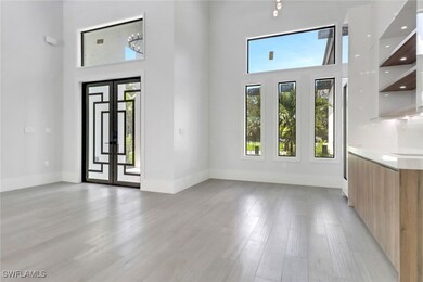 Front entry and dining room featuring impact glass