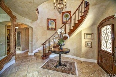 Custom iron and wood front door and staircase