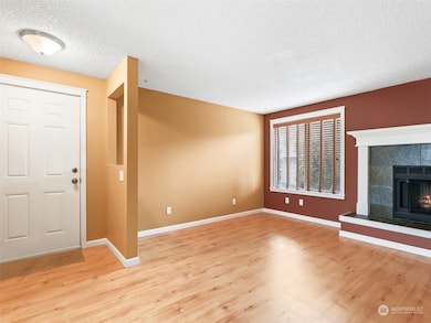 Front Door & Living Room w/ Wood-Burning Fireplace