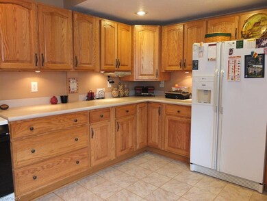Large kitchen with tile backsplash.