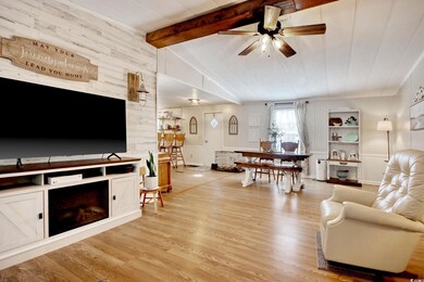 Living room with a fireplace, vaulted ceiling with