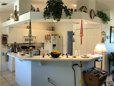 Sitting at the bar looking into the kitchen. Compl
