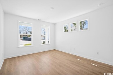 Empty room with visible vents, baseboards, and wood finished floors
