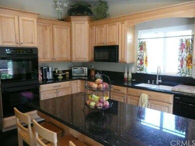 Custom maple cabinets, slab granite and newer blac
