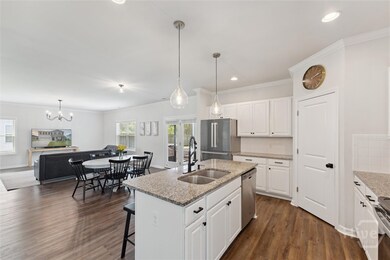 Kitchen with view into the family room and screene