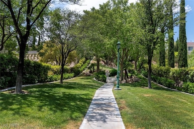 View of home's community with a lawn