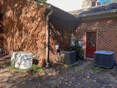 Doorway to property with central AC unit