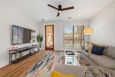 Living area with baseboards, visible vents, wood 