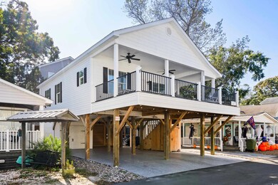 View of front of house featuring a deck and ceiling fan