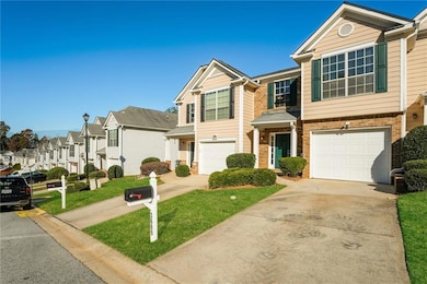 Traditional-style home featuring brick siding, concrete driveway, a residential view, a front lawn, and a garage