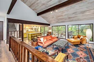 Vaulted ceilings and walls of windows make this home light and bright.