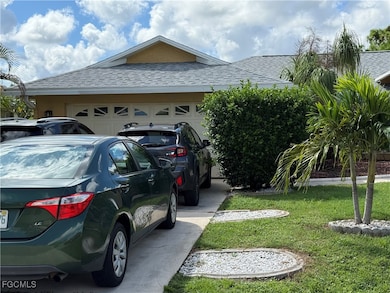 View of side of home featuring a shingled roof, a garage, driveway, and stucco siding