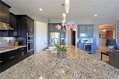 View of built-in dry bar and wine refrigerator