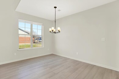 Spare room with light hardwood / wood-style flooring and a notable chandelier