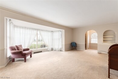 Another view of living room featuring bay window
