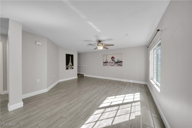 Unfurnished living room with wood finish floors and a ceiling fan